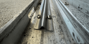 Stainless steel track cover installed during impact sliding glass door track repair